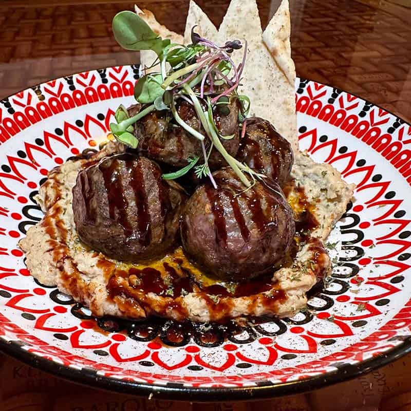 Our award-winning Greek lamb meatballs served on a bed of smoked eggplant hummus. Served with warm pita bread