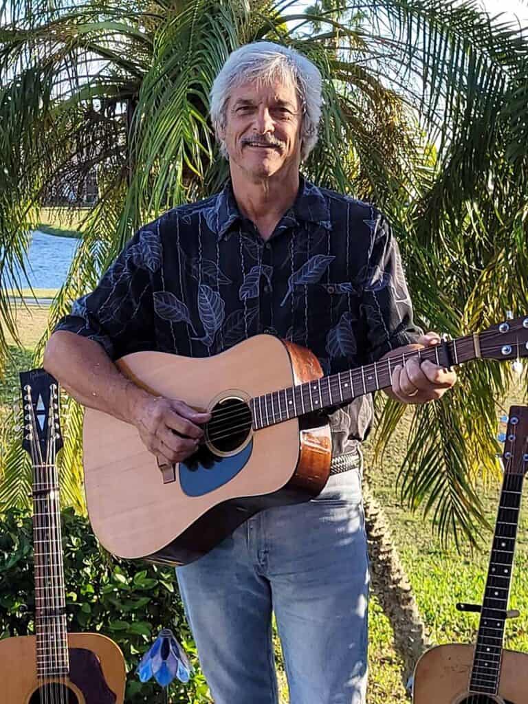 Musician Andy Mauck playing guitar outdoors