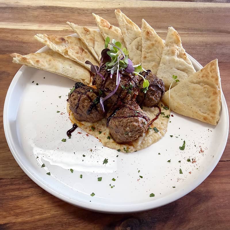Our award-winning Greek lamb meatballs served on a bed of smoked eggplant hummus. Served with warm pita bread